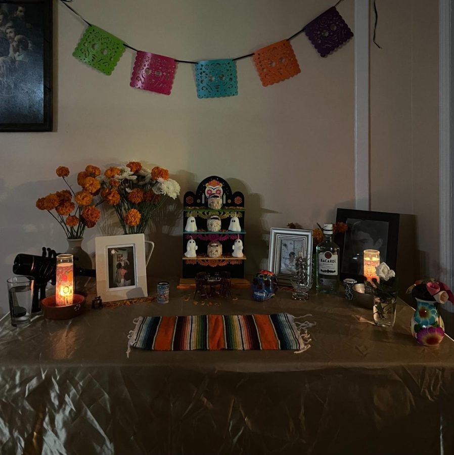 My family’s ofrenda dedicated 
to my grandparents with traditional
 Dia de los muertos staples such as 
marigold flowers, sugar skulls, 
candles, and papel picado (banners 
made out of paper or plastic panels 
that are cut  with intricate designs). 
Photo credits to Melanie Garduno. 
