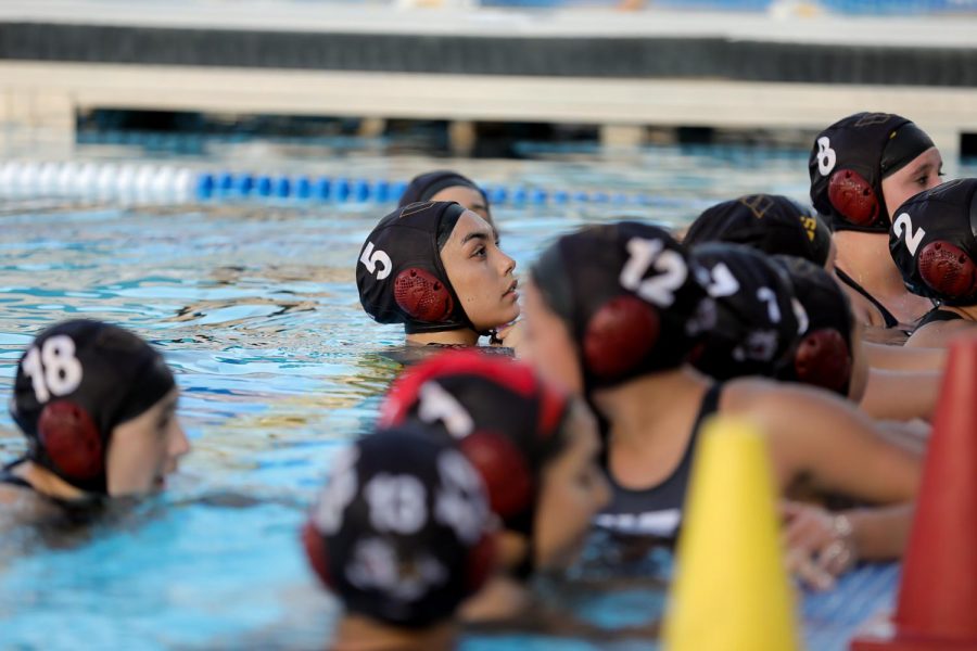 Senior Salma Valle and the girls water polo team talking to Coach Vincent during halftime at Senior Night on Feb. 2. 