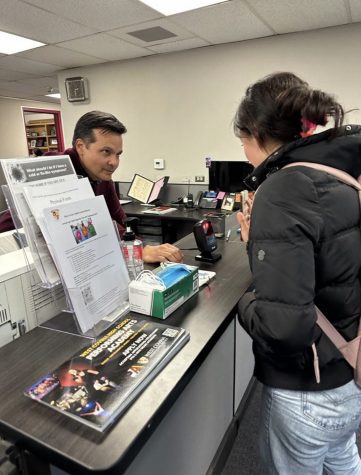 A student scans her digital ID in the front office to leave the school on March 3.  Photo Credits: Salma Valle