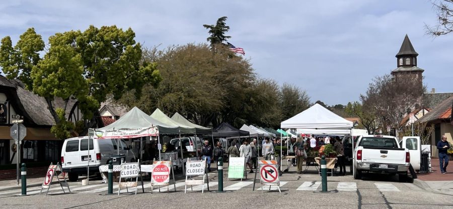 A morning street market sets up while tourists browse what’s on the market in Solvang, Calif. on Apr. 13.