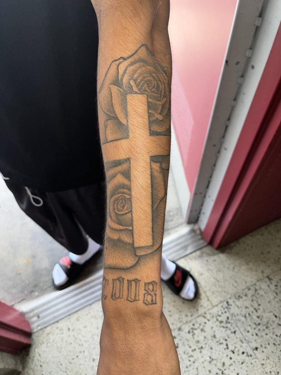 Sophomore Miguel Carranzas forearm tattoo a rose with a cross and the year he was born.