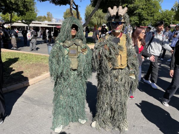 Andrew Navidad and Anthony Huynh remain stealthy in their ghillie suits and tactical gear. Moving around campus, they show off their knowledge and interest in the military world through their accurate depiction of what a sniper looks like. Dressed in camo green grassed draped suits, Navidad and Huynh show off their costumes, feeling most confident about their various accessories.