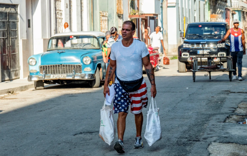 A man dresses in clothing depicting the American flag walking the streets of Cuba on Oct. 31, showing the positive attitude towards the United States. Photo by Yamil Lage/NBC News