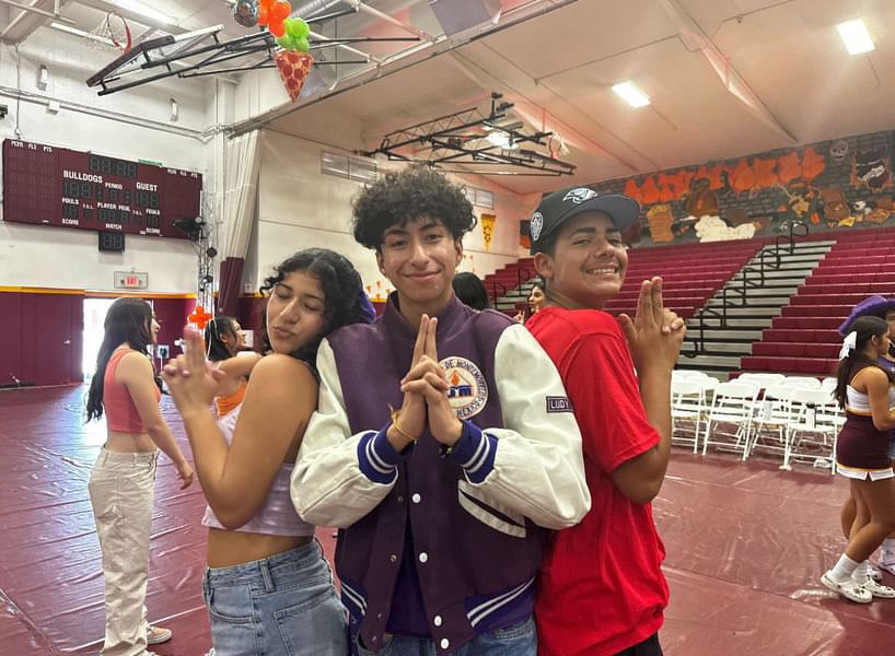  Melanie Herrera, Alejandro Martinez Cavazos, and Isaac Nunez celebrating a successful welcome back rally at the beginning of the school year. 
