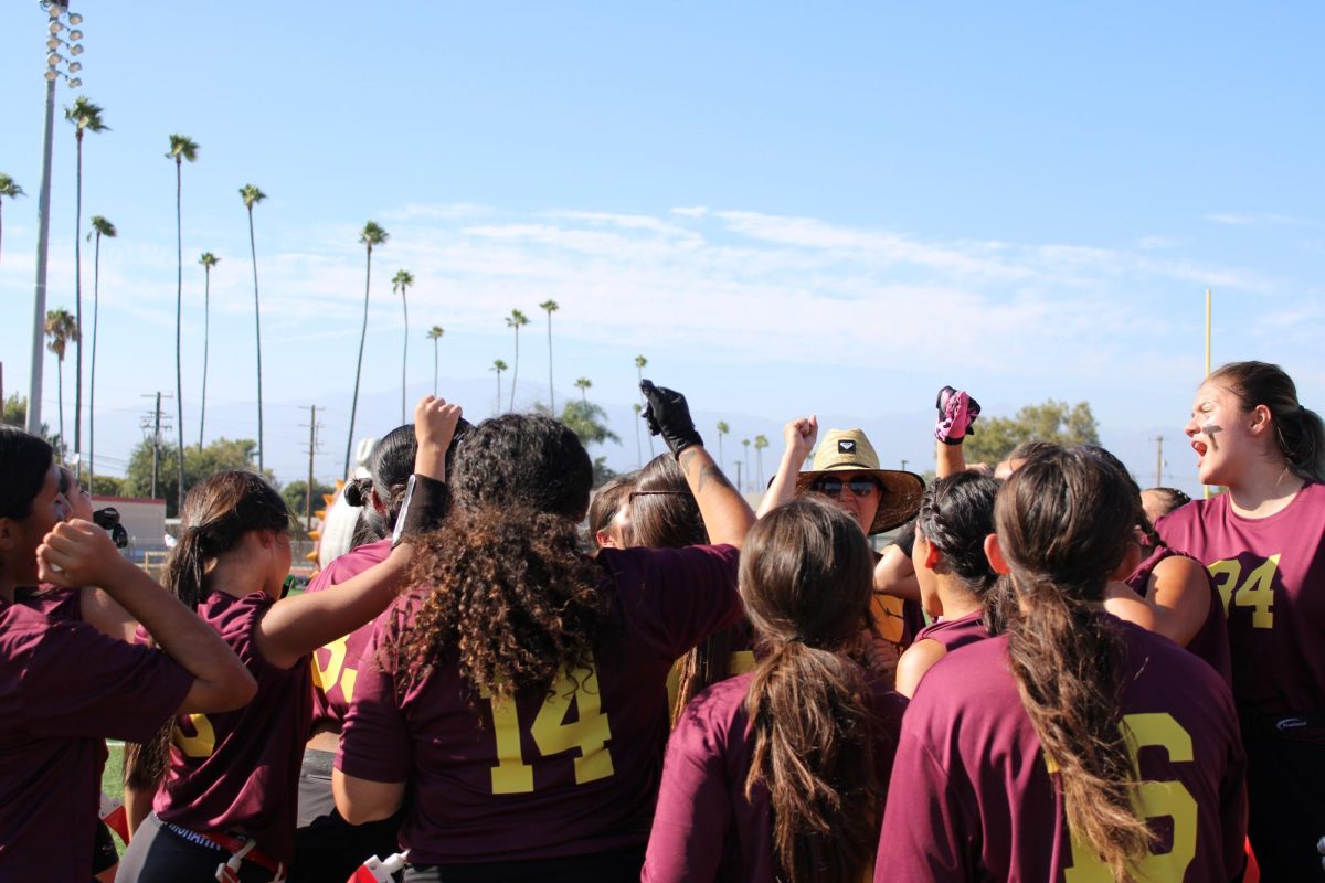  The flag football team listens to a pep talk from Head Coach Rebecca Hernandez before their game against San Dimas. Following this was a chant that precedes every Bulldog sporting event,“Bulldogs on me, Bulldogs on three, one, two, three, Bulldogs!”