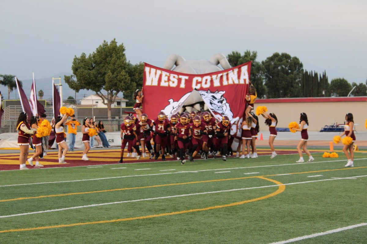 At 6:45 p.m., the football team started their usual pregame chant “give me two beats, give me two claps, ooh ah,” to get their players riled up. The evening officially began with the Bulldogs sprinting through the West Covina banner as the cheer team surrounded them and the stands erupted in excitement for kickoff. 
