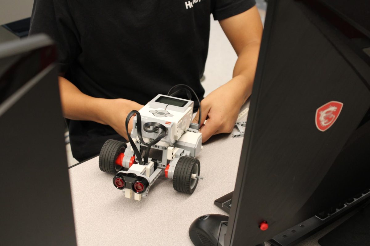 Sophomore Kobe Ma with his Lego Robot. The robots use touch sensors to move and stop the robot. “We use Robotic C to code the robot,” said Ma.