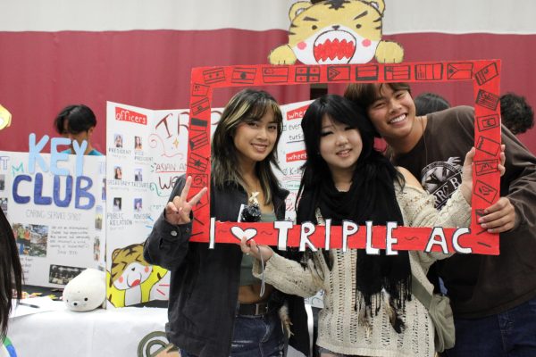 Left to right: Senior officers of Triple AC,  Star Yun, Chris Tam, and Haley Isip display their club board. This club shows the importance of Asian culture and covers the different Asian cultures. “Triple AC is a way to spread Asian American appreciation and to learn more about the diversity of many cultures that Asia has, and to try and spread awareness,” said Isip. 
