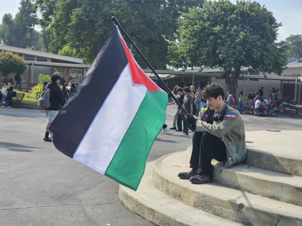 Senior Gabriel Vincent Franco sits at the circle stage and holds a Palestinian flag to raise awareness regarding the Israeli-Palestinian conflict today. He was anxious to go forward with his plan and discussed it with his parents the night before. “Yesterday I was worried that something would happen, so were my parents… So we talked about it and I thought about it and I came to the decision that I’m not doing anything wrong,” said Franco. 
