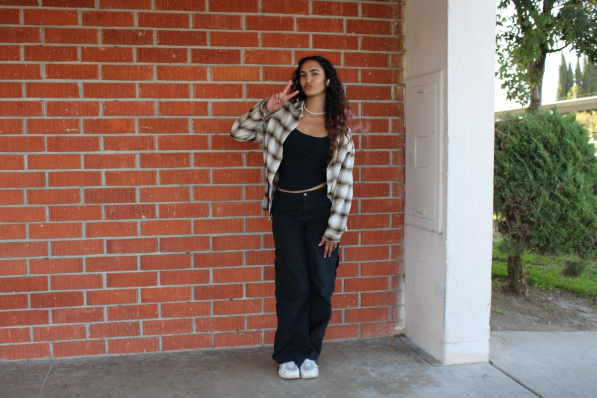 Senior Mya Salama’s fall outfit consists of a Forever 21 tank top, a thrifted flannel and white sneakers. Salama draws inspiration from streetwear with a seasonal touch by combining baggy jeans with a brown flannel and takes a relaxed approach to putting together her outfits. Salama’s two favorite stores to shop at to achieve her easy going style are Tilly’s and PacSun. “My favorite stores I feel like Tilly’s maybe… PacSun, Tilly’s and yeah I think that's it,” said Salama.