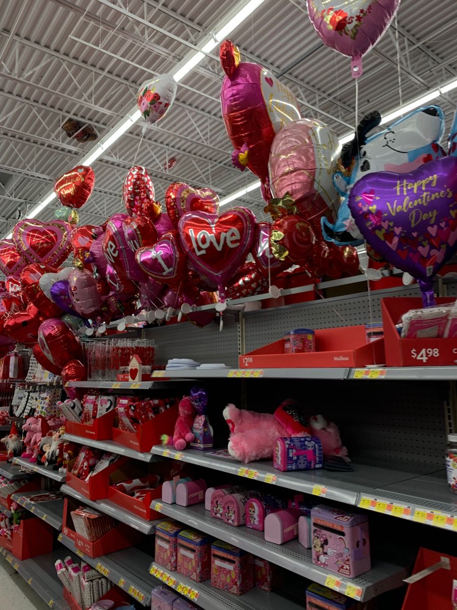 An aisle filled with Valentine’s Day balloons and gifts at Walmart, showcasing the consumer driven shift of the holiday where the focus has shifted from love to material gifts.
