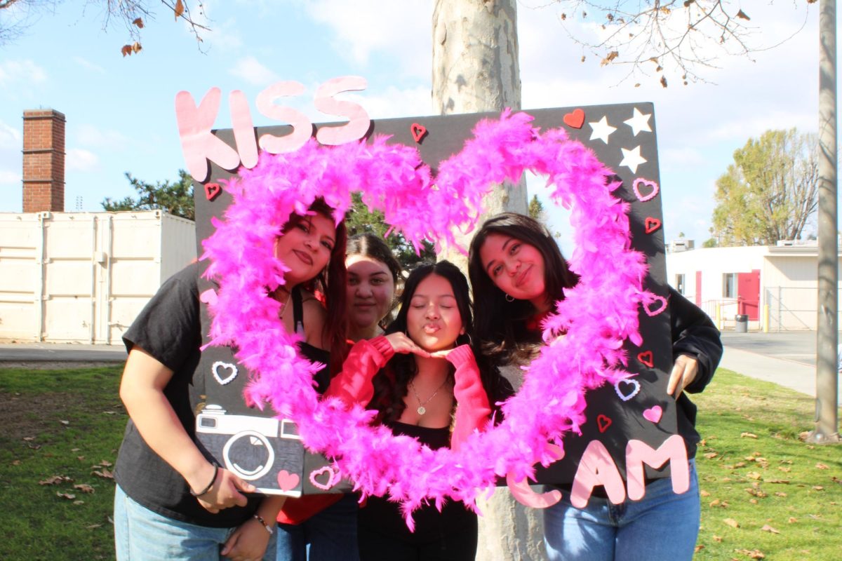 From left to right seniors Anahi Gonzalez, Johanna Gomez, Kimberly De Paz, and Luna Rivas Cabuto with a “Kiss Cam” photo prop. For Galentine’s Day, Kimberly De Paz and her friends give each other gifts and express their appreciation for each other. She mentions that her appreciation for friendships has grown as she realizes their long-term significance in her life. 
