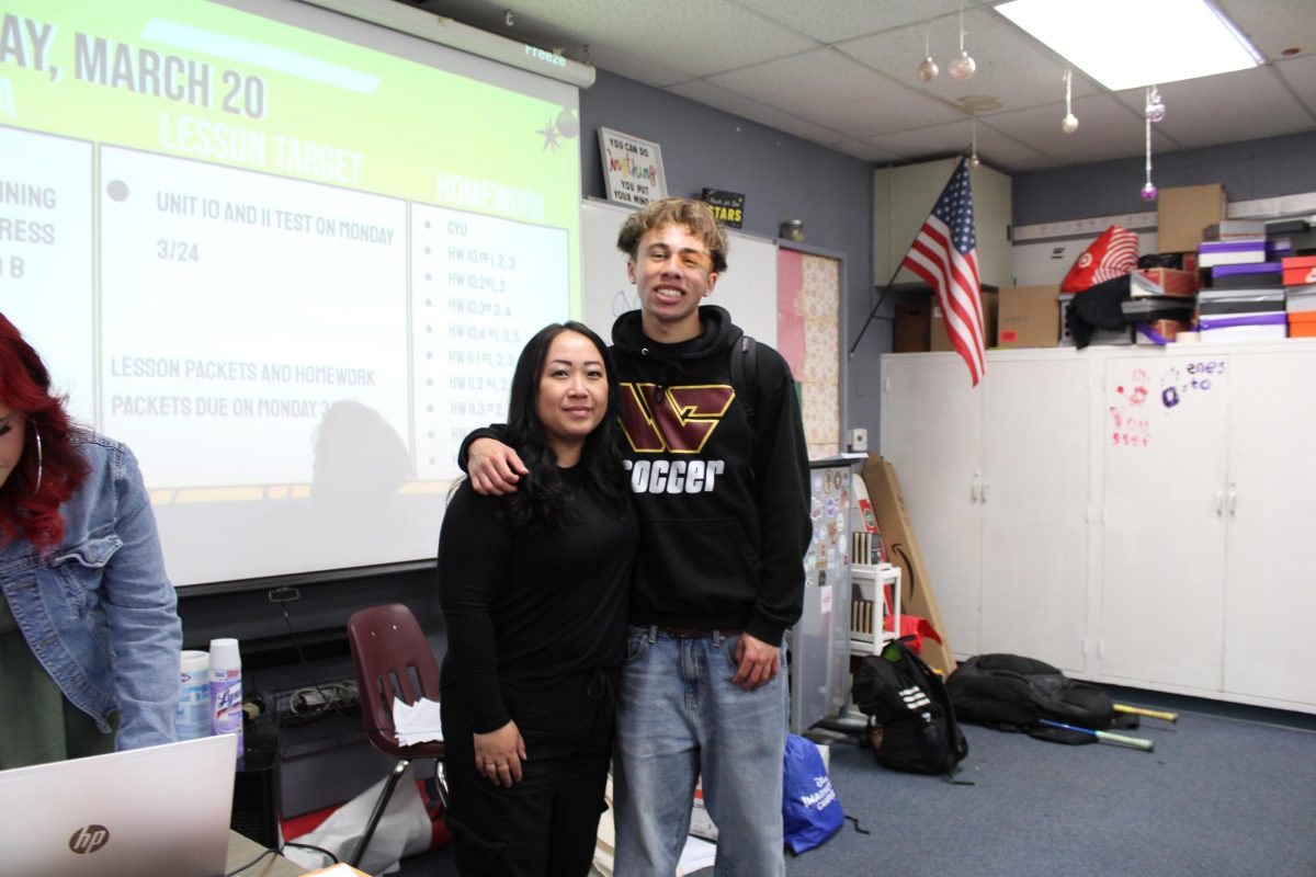 Senior Ashton Sangeadeo and AVID and math teacher May Casas show the supportive bond that can form between teachers and students when trust and respect are built in the classroom. 
