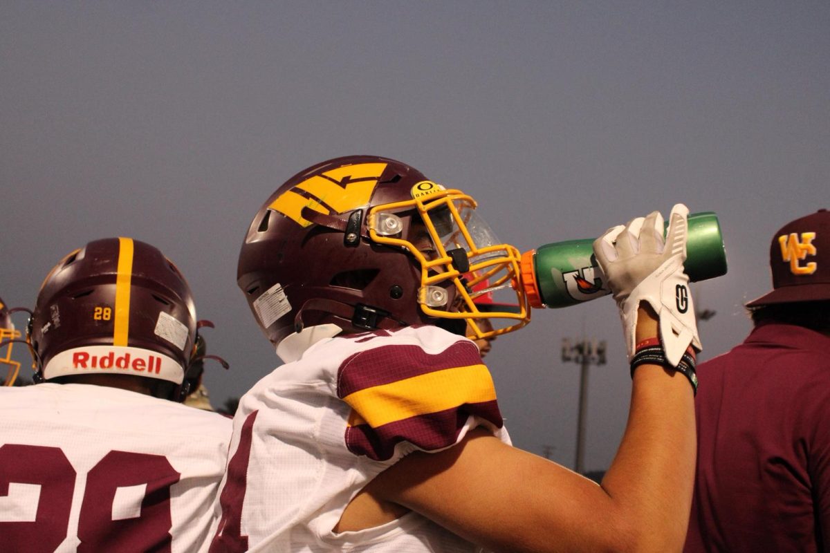 Junior Jonathan Higareda takes a water break during the Football Kings of Cameron game last Friday. Higareda took the break during the second quarter, with the score at 14-0. Water breaks help ensure players stay hydrated and perform at their full potential.