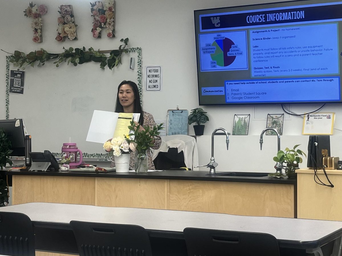 Annie Tam, the human anatomy and physiology teacher, gives an explanation of her class during Back To School Night through a presentation. Tam's classroom was barely filled, only about six students who came to view her presentation. Photo by William Xu