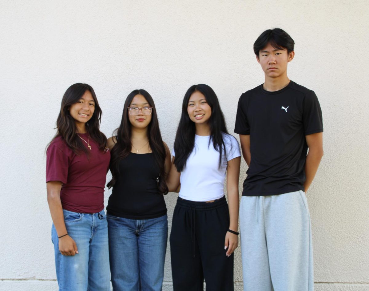 Left to right, Madeline Salas, Rio Che, Caitlin Nguyen and Alvin Chen stand together after a small debate about where they should each stand. Salas argued that Chen needed to stand closer to everyone while Che agreed and joked. "Act like you wanna be here," said Che.