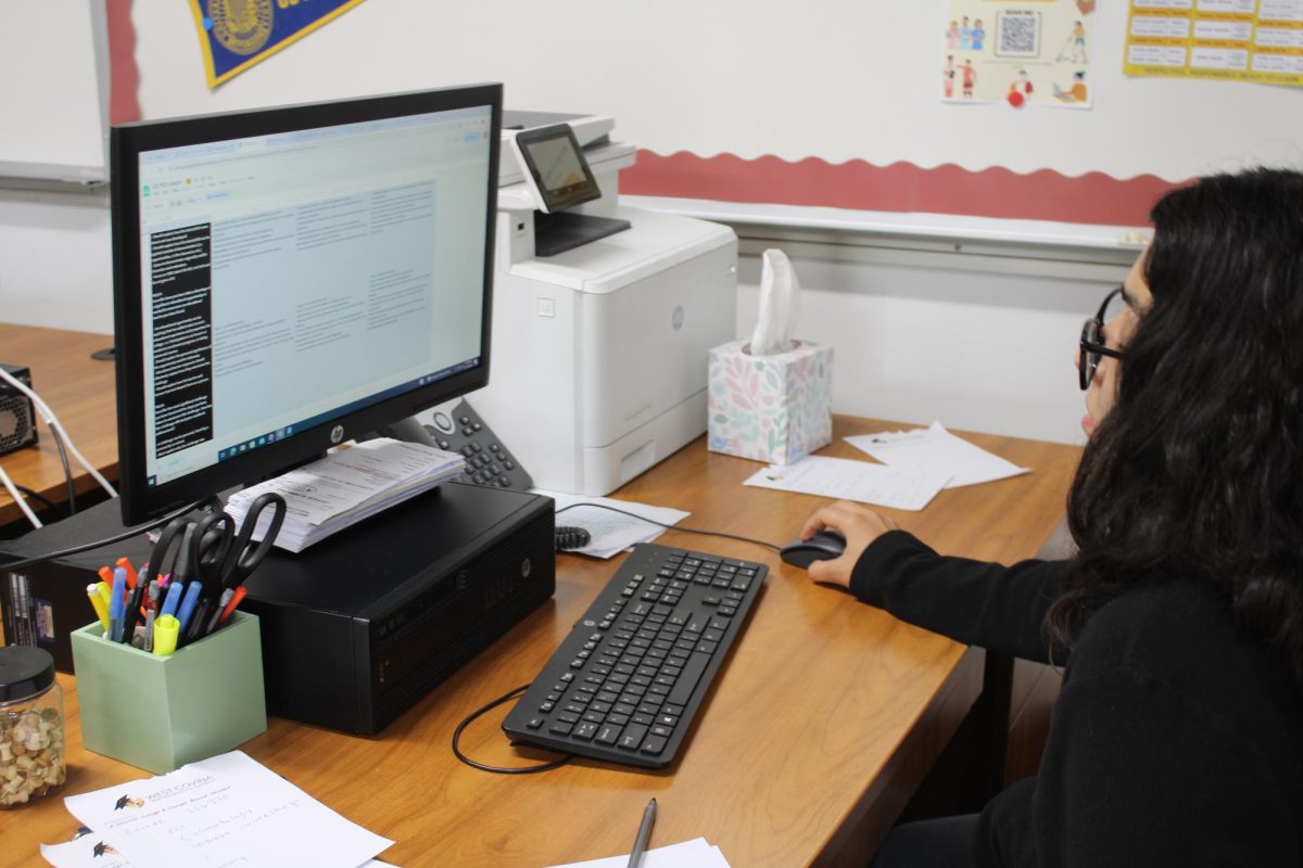 College Advisor, Kessie Aguilar reviews documents to support students in applying for college. Aguilar acknowledges that it is always difficult for students on the topic of college. “Every year it’s getting harder and harder to get admitted into universities,” Aguilar said. 
