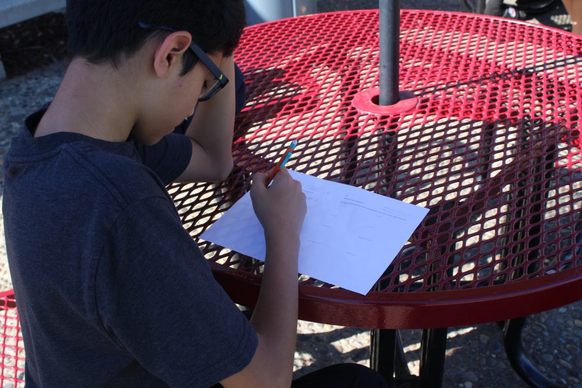 Isiac Calvillo, 11, tries to complete his homework during nutrition by using his own knowledge from class. Though Calvillo struggled, he didn’t use AI and completed his homework in time for a satisfactory grade. "To some extent, not for like, a whole assignment," Calvillo said, responding to a question about if AI is a good source that should be used regularly. Photo by William Xu
