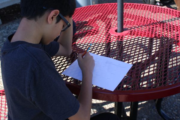 Isiac Calvillo, 11, tries to complete his homework during nutrition by using his own knowledge from class. Though Calvillo struggled, he didn’t use AI and completed his homework in time for a satisfactory grade. "To some extent, not for like, a whole assignment," Calvillo said, responding to a question about if AI is a good source that should be used regularly. Photo by William Xu
