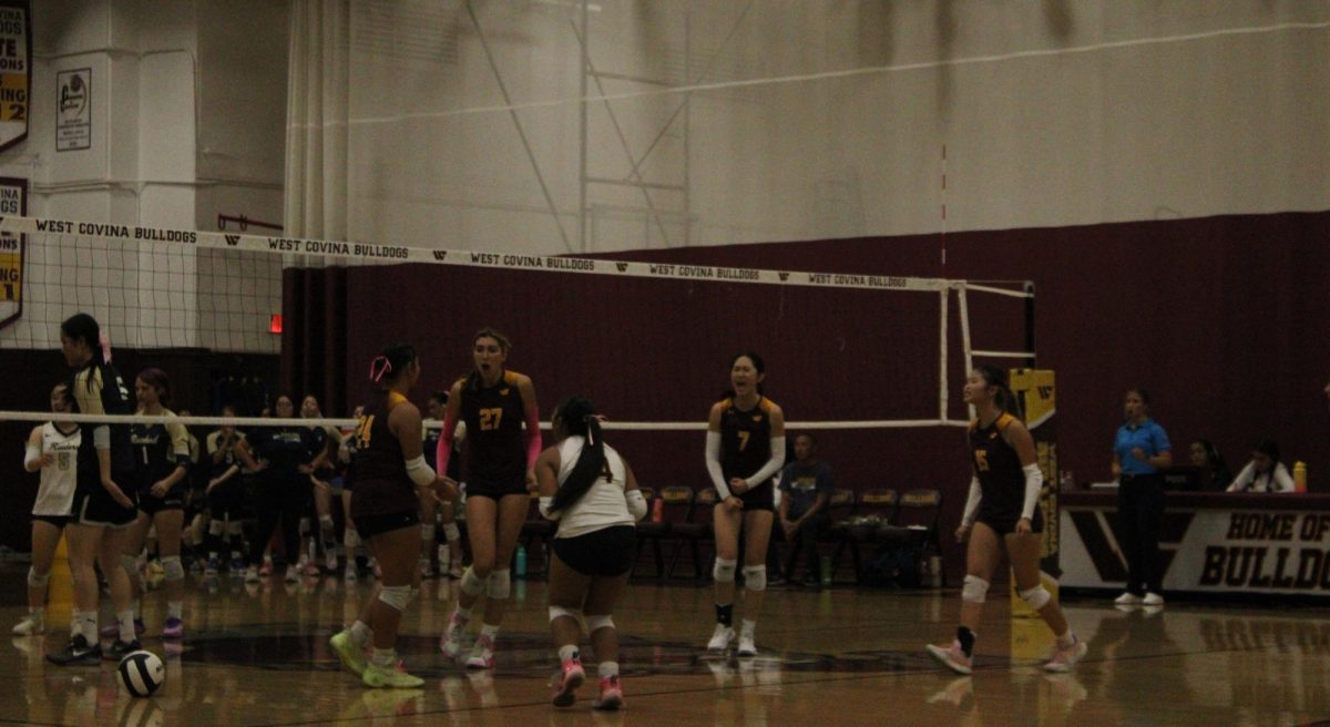 Left to right, seniors Taylor Maranan, Isabella Gonzales, Linh Diep, juniors Colbie Maranan and Olivia Hoang celebrate the win of the fourth set. At this time the score for the win was tied which later changed to Rowland's win. "If any team is gonna go to CIF, like, from West Covina, it should be our team," Taylor Maranan said.