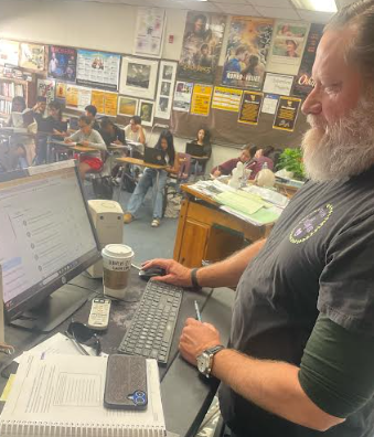 English teacher Theodore Moser works at his desk in class, while his freshman students focus on their work. Teachers also see a positive change in students’ study habits.