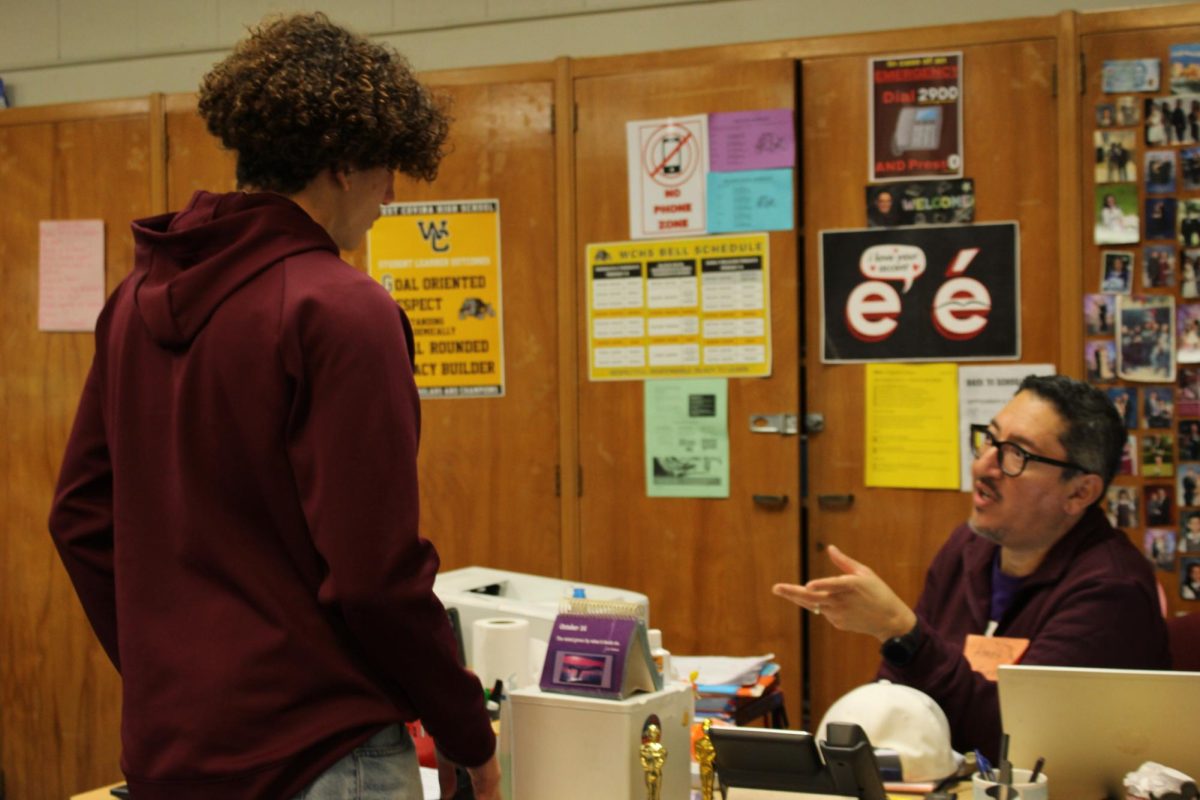Sophomore Vance Davis asks Orlando Centeno a question; the inquiry being to grab an item from another class, Centeno helped Davis ask his question in Spanish.