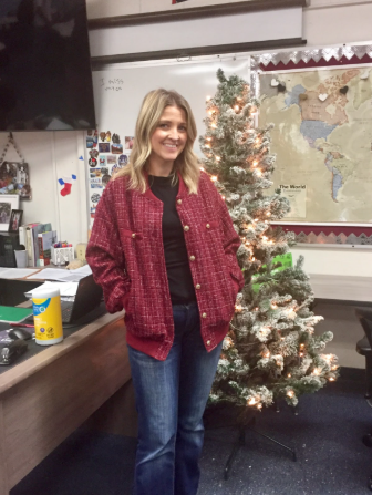 History teacher Kathryn Cayem stands in front of the Christmas tree in her K–9 classroom. Though the holiday is still a month away, she’s looking forward to the upcoming celebrations.