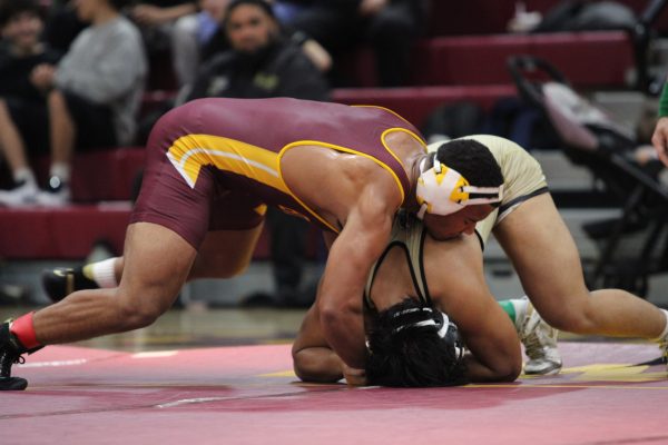 Senior and varsity wrestler Josiah Joseph competes during Tuesday night’s wrestling Senior Night match. He demonstrated focus and determination throughout his bout, maintaining control against his opponent. Joseph earned a victory for the team, standing out during a challenging night of competition. His performance highlighted his effort and resilience on the mat.