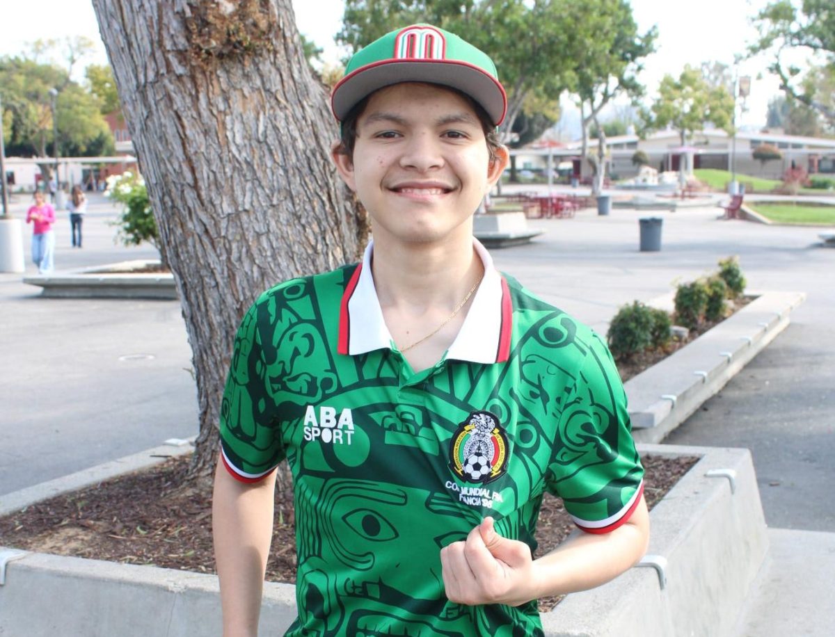 Junior Eric Sanchez holds the badge of his Mexico soccer jersey. Sanchez will be supporting Mexico at the World Cup this summer.
