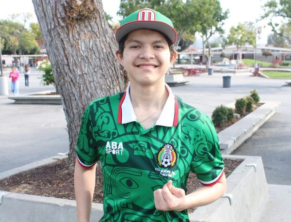 Junior Eric Sanchez holds the badge of his Mexico soccer jersey. Sanchez will be supporting Mexico at the World Cup this summer.