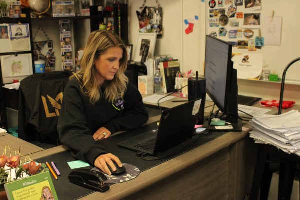 AP Seminar and social science teacher Kathryn Cayem works on inputting grades at her desk. “I think the scope of AI has gotten so much bigger within the last year and a half that I am more concerned about it now, and I'm more concerned about the inability to regulate the usage of AI,” Cayem said.