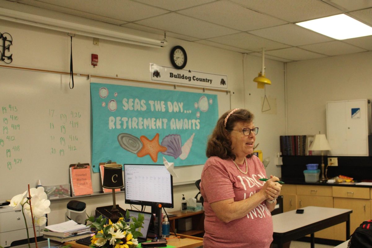 Cyhaniuk with a retirement poster behind her. 
