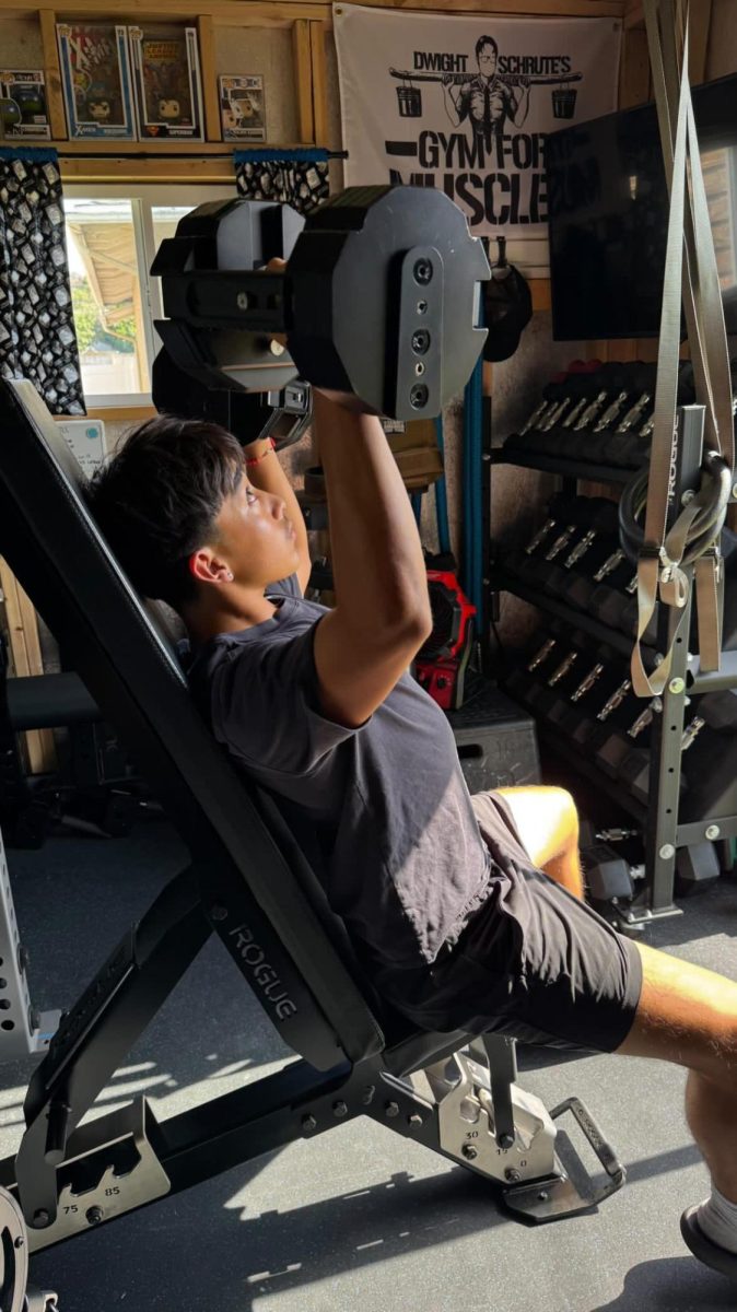 Junior Joshua Ling completes a shoulder workout, pressing 55lbs in his at-home gym. Getting enough sleep and eating healthy throughout the day helps him feel energized to push through his workouts, stay strong, and build muscle. “If you get the right amount of sleep, your body feels light, you can move, your joints are all good, and it feels like you're in the zone,” Ling said.